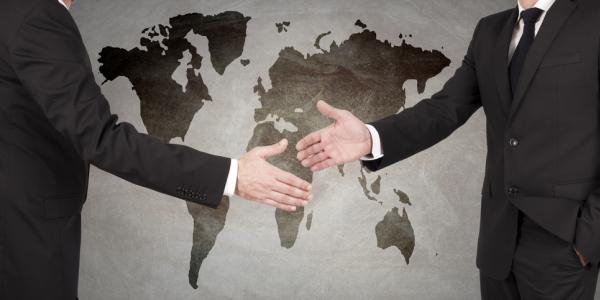 handshake in front of world map